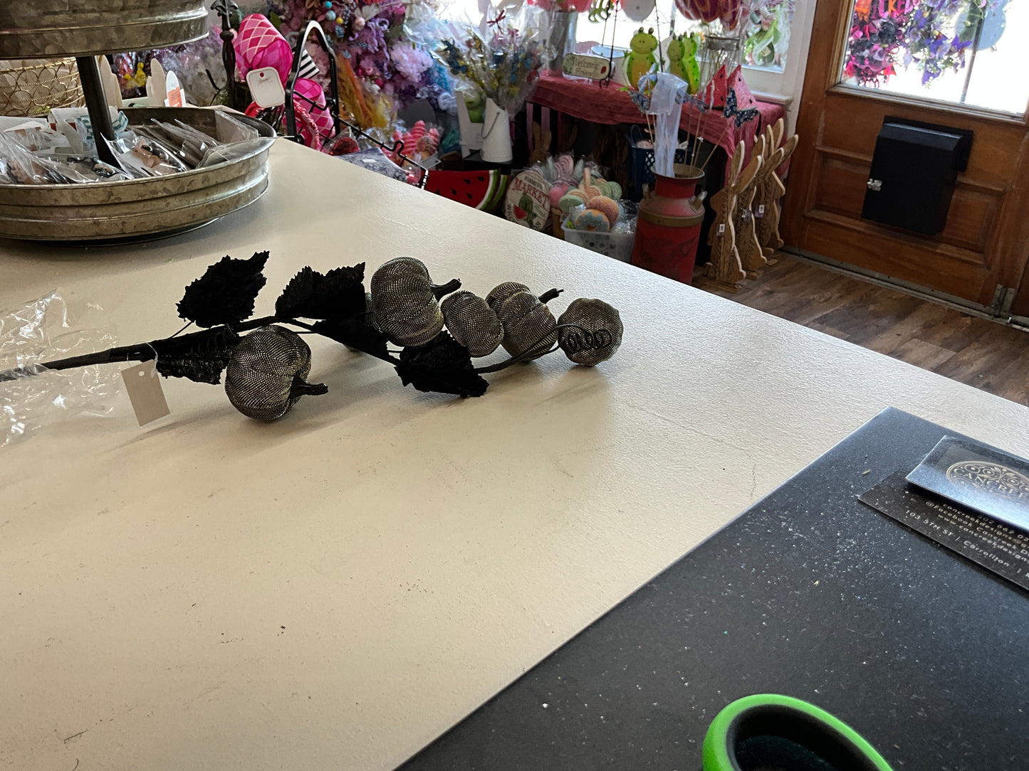 Black shimmer pumpkin with leaves spray